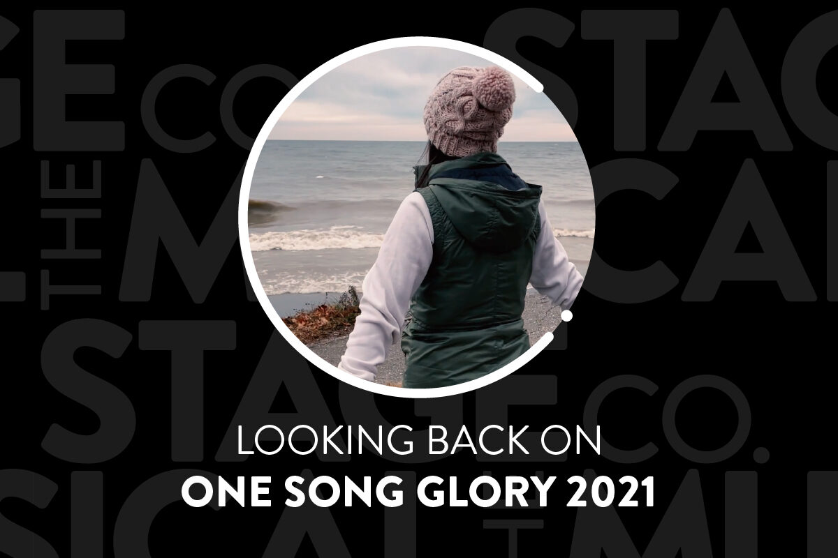 A black background has faded Musical Stage Company logos overlaid. Centered is a circular image, with a white 'C' and '.' border. Pictured is a youth in winter layers & a toque, their back to the camera & facing a shoreline. Text under reads, “Looking back on / One Song Glory 2021.”